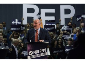Premier John Horgan speaks at rally in Victoria in support of proportional representation.