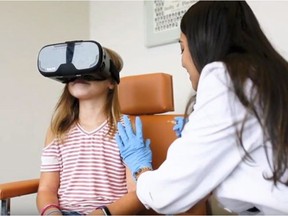 A child wearing virtual reality glasses receives a flu shot in a handout photo. THE CANADIAN PRESS/HO-Whole Health Pharmacy Partners MANDATORY CREDIT