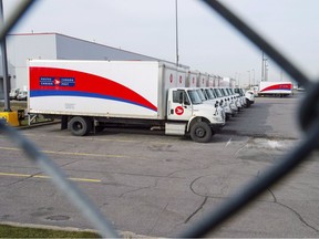 Idle Canada Post trucks sit in the parking lot of the Saint-Laurent sorting facility in Montreal as rotating strikes hit the area on Thursday November 15, 2018.