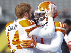 B.C. Lions quarterback Travis Lulay (14) has a moment with teammate Odell Willis (11) during warm-up before CFL Football division semifinal game action in Hamilton, Ont. on Sunday, November 11, 2018.
