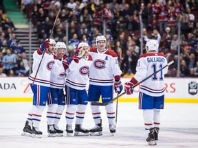 Montreal Canadiens' Phillip Danault, from left to right, Max Domi, Jonathan Drouin, Jeff Petry and Brendan Gallagher celebrate Drouin's goal during the third period of Saturday's NHL game against the Canucks in Vancouver. Montreal won 3-2.