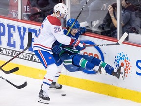 Montreal Canadiens' Jeff Petry checks Vancouver Canucks' Brendan Leipsic during the second period on Saturday night.