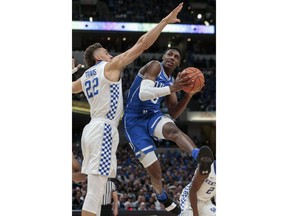 Duke forward RJ Barrett (5) shoots around Kentucky forward Reid Travis (22) during the first half of an NCAA college basketball game at the Champions Classic in Indianapolis on Tuesday, Nov. 6, 2018.