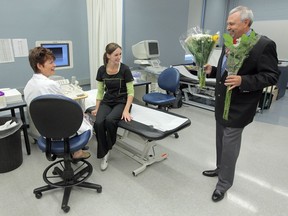 Gary Watson presented instructor Carrie Hopkins, left, and student Jill Schwarzenberger, both of SAIT's Diagnostic Medical Sonography department, with flowers at SAIT in Calgary Alberta on June 24, 2011. Watson volunteered for an abdominal ultrasound during one of SAIT's Diagnostic Medical Sonography classes when Schwarzenberger discovered he had an Abdominal Aortic Aneurysm. Watson immediately sought help and was able to repair the potentially fatal aneurysm. Watson credits the SAIT student for saving his life.