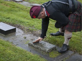 Volunteers braved the rain on Saturday, Nov. 3 to clean the moss and debris from the graves of fallen soldiers at Fraser Cemetery in New Westminster, BC. The cleaning of the headstones, a program called Teaching Children to Remember organized by the Society of the Honourable Guard, is meant to commemorate Canada's fallen soldiers.