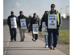 Richmond, BC: NOVEMBER 10, 2018 -- Striking postal workers walk the picket line at the Canada Post Pacific Processing Centre in Richmond, BC Saturday, November 10, 2018. The rotating strike, in effect since October 22, has affected mail delivery across the country. Negotiations continue.