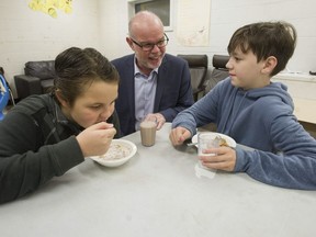 The Vancouver Sun and The Province Editor-in-Chief Harold Munro speaks to James Ardiel Elementary school Grade 6 students Roan O'Keefe (left) and Caleb Grant, during a meeting of the Surrey school's Breakfast Club.