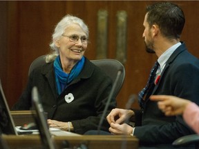 Jean Swanson talks with Michael Wiebe as Vancouver's new mayor and council had their first meeting at city hall in Vancouver on Nov. 5.