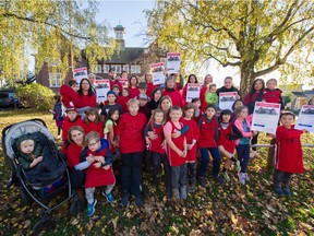 Parents and kids, along with Sacha Iley, front centre, with her children Alexander Elliott and Alyse Elliott, in front of Edith Cavell Elementary School in Vancouver on Nov. 6. Vancouver parents are upset at the school board's plan to bus kids across town during a seismic upgrade.