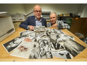 Editor-in-Chief Harold Munro and reporter John Mackie look over archival photos from The Province's Empty Stocking Fund.