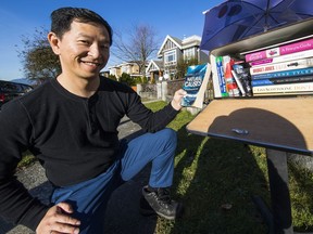 Jason Cao at the nearby book exchange in Vancouver that he created for his community.