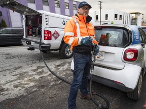 Dustin Ellis of Filld prepares to fuel up a Car2Go vehicle. The company is now offering its service to the public.