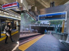 Edmonds Station in Burnaby on Nov. 27. Poster at right shows newly designed signage that TransLink will place in all SkyTrain stations.
