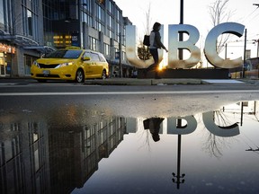 U.B.C. glows in the late evening light while students walk around the campus.