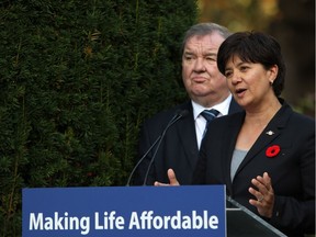 Parliamentary Secretary and co-chair Mable Elmore discusses details about members of an advisory forum on poverty reduction as Minister of Social Development and Poverty Reduction Shane Simpson looks on during a press conference from the Rose Garden at Legislature in Victoria, B.C., on Monday, October 30, 2017.