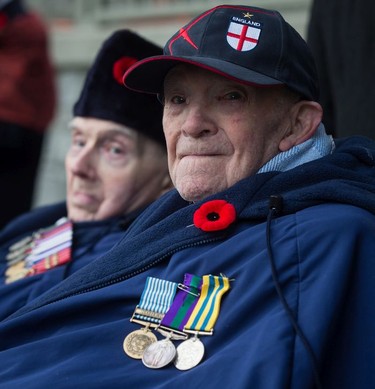 Second World War veterans Sidney Elston, front right, 91, and Howard Costain, 98, wait for a Remembrance Day ceremony to begin in Vancouver, on Sunday November 11, 2018.