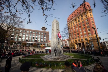 A Royal Canadian Air Force Sea King helicopter from the 443 Maritime Helicopter Squadron flies past a Remembrance Day ceremony at the Victory Square Cenotaph in Vancouver, on Sunday, November 11, 2018.