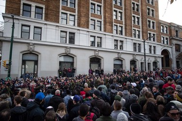 People watch as members of the Canadian Forces march past during a Remembrance Day ceremony in Vancouver, on Sunday November 11, 2018.