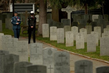 Military members walk amongst gravestones during a Remembrance Day ceremony at God's Acre Veteran's Cemetery in Victoria on Sunday, November 11, 2018.