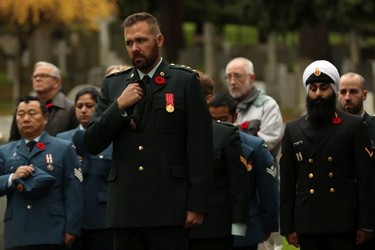 Military personnel observe a moment of silence at Remembrance Day ceremonies at God's Acre Veteran's Cemetery in Victoria on Sunday, November 11, 2018.
