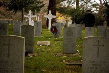 A Royal Canadian Navy personnel pays his respects during a Remembrance Day ceremony at God's Acre Veteran's Cemetery in Victoria on Sunday, November 11, 2018.