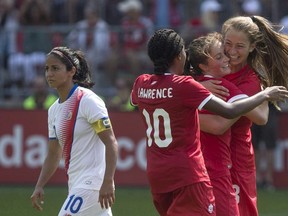 Canada's Jordyn Huitema, right, celebrates with Ashley Lawrence (10) and Jessie Fleming after scoring her second goal and her country's sixth as Costa Rica's Shirley Cruz walks by during International soccer action in Toronto on June 11, 2017.