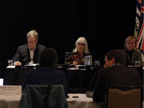 Members of the National Energy Board panel from left, Murray Lytle, Lyne Mercier and Alison Scott listen to Councillor Andrew Victor of Cheam, left, Sto:lo Tribal Chief Tyrone McNeil and lawyer Tim Dixon as they deliver traditional evidence from Indigenous groups as part of its review of the marine shipping impacts of the Trans Mountain pipeline at the Delta Hotels Victoria Ocean Pointe Resort in Victoria, B.C., on Monday, November 26, 2018.