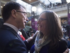 Morgane Oger, right, greets British Columbia Health Minister Adrian Dix following an announcement at the Vancouver General Hospital in Vancouver, B.C. Friday, Nov. 16, 2018. The announcement provided information on how transgender people in British Columbia will soon have access to publicly funder gender-affirming lower surgeries within the province.