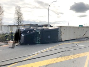 An overturned truck is leaking diesel on River Road.