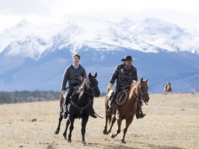 Prime Minister Justin Trudeau, left, and Chief Joe Alphone of Anaham and several other Chiefs of the Tsilhqot'in National Government ride horseback near Chilko Lake, B.C., Friday, Nov. 2, 2018. The Prime Minister was in the area to apologize to the Tsilhqot'in  community for the hangings of six chiefs during the so-called Chilcotin War over 150 years ago.