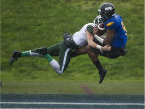 Malcolm Le of the UBC Thunderbirds intercepts the pass intended for Jesse Kuntz of the Saskatchewan Huskies during Saturday's Hardy Cup semifinal football game at Thunderbird Stadium in Vancouver. Saskatchewan won a thriller in overtime.