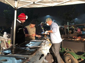 Paul Klyne of Penticton, B.C., helps with an impromptu kitchen for wildfire evacuees in Chico, Calif., in this recent handout photo.