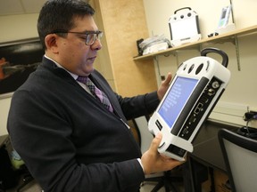 Dr. Ivar Mendez with some of the robots in the Medical Arts Building at the U of S in Saskatoon on February 11, 2015. Bridges photo by Michelle Berg
