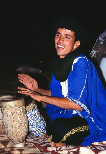 A Tuareg plays drums at the camel safari camp.