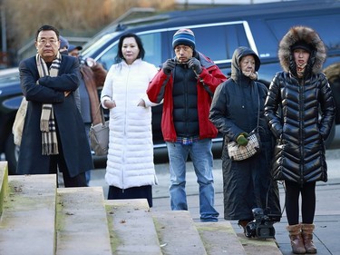 Observers stand outside the B.C. Supreme Courthouse as they wait for news at the bail hearing for Huawei Technologies Chief Financial Officer Meng Wanzhou in Vancouver on Dec. 7, 2018 in Vancouver.