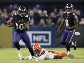 Running Back Kenneth Dixon of the Baltimore Ravens runs with the ball in the second quarter against the Cleveland Browns.