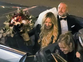 Annie Arbic arrives with Hells Angel member Martin Robert in a convertible Cadillac for their wedding in downtown Montreal on Saturday Dec. 1, 2018.