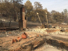 The remains of a house recently burned in northern California. Centre left are two fire-blackened pots. The owners escaped unscathed.