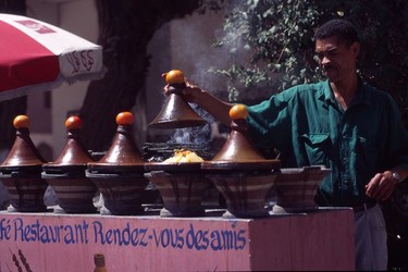 Street vendor selling tajines cooking in their conical-lidded tajine pots (Marrakech).