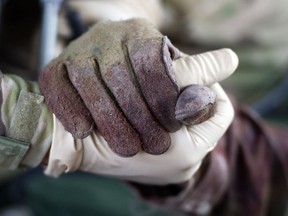 US army Flight Medic Brandon Lowther (L) holds the hand of a fatally wounded US army soldier as he is airlifted by the Medevac helicopter of 159th Brigade Task Force Thunder on August 24, 2011 to Kandahar Hospital Role 3. Two US soldiers were heavily injured by gun shots and brought to the hospital. All foreign combat troops will leave Afghanistan by the end of 2014 in a process that started last month and will require the Afghan army and police to play an ever-greater role in fighting the Taliban insurgency. AFP PHOTO/Johannes EISELE