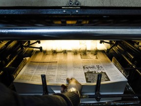 A technician retrives a freshly-printed page of the Afrika Gazetesi newspaper's forthcoming edition from the printing press, at its printhouse in the northern side of the Cypriot capital Nicosia in the self-proclaimed Turkish Republic of Northern Cyprus (TRNC), on December 13, 2018. - Jail time and angry mobs -- editor Sener Levent has paid a price for challenging the might of Turkey's President Recep Tayyip Erdogan and local authorities in breakaway northern Cyprus with his newspaper. In January, hundreds of protesters attacked the offices of the newspaper -- a tiny daily with a 1,500 circulation in a statelet of around 300,000 people -- after it ran an article criticising a Turkish military offensive against the Kurdish border enclave of Afrin in Syria. (Photo by Amir MAKAR / AFP)AMIR MAKAR/AFP/Getty Images