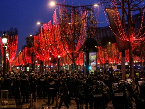 French riot police disperse Yellow Vest protesters on the Champs-Elysees in Paris.