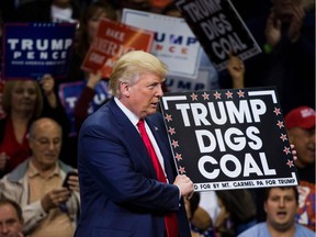 U.S. President Donald Trump, a fervent supporter of the coal industry, holds a sign supporting coal during his campaign for the presidency at a rally in Wilkes-Barre, Penn., in October 2016.
