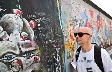 A traveller checks out a section of the East Side Gallery.