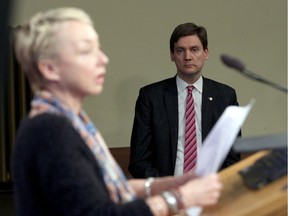 Attorney General David Eby looks on as Jane Dyson, executive director of Disability Alliance BC, speaks about the changes coming to the Insurance Corporation of B.C. during a press conference in the press gallery at Legislature in Victoria, B.C., on Tuesday February 6, 2018.