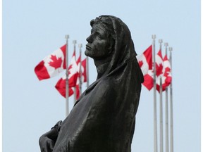 The statue of Veritas (Truth) is pictured in front of the Supreme Court of Canada in Ottawa on Wednesday, May 23, 2018. The Supreme Court of Canada has struck down a law that forces people convicted of crimes to pay surcharges that help victims, saying the mandatory fee amounts to cruel and unusual punishment.