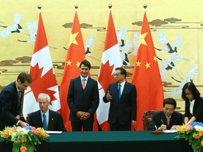 Chinese Premier Li Keqiang (C-R) and Canadian Prime Minister Justin Trudeau (C-L) attend a signing ceremony after a meeting at the Great Hall of the People in Beijing, China, August 31, 2016. Diplomat Michael Kovrig (left) and Foreign Affairs Minister Stephane Dion (second from left) also attend.