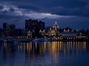 The British Columbia Legislature is reflected in the waters of Victoria harbour in the early morning in Victoria, B.C. Monday, Jan. 16, 2012. Staff and contractors in Victoria have been crunching the numbers on climate change costs and it's not looking good, the coastal city's mayor says. Lisa Helps pointed to a report commissioned by the regional government in 2015.