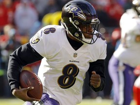 Ravens quarterback Lamar Jackson runs with the ball during the first half of an NFL game against the Chiefs in Kansas City, Mo., Sunday, Dec. 9, 2018.