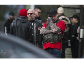 A Hells Angel mourner wipes his eyes outside funeral service for murdered HA member Chad Wilson